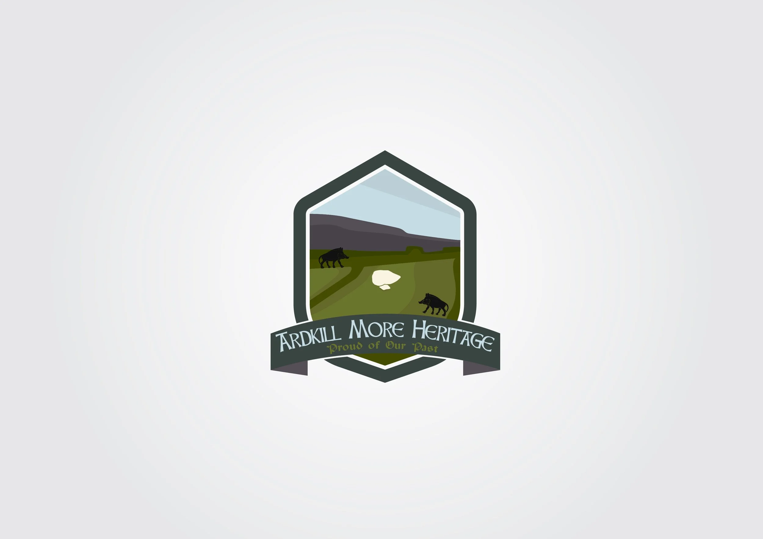 A logo for Ardkill More Heritage featuring a shield with a landscape of a green field, gray mountain, and cloudy sky, with two black animals on either side of a white stone, and a banner below reading 'Proud of Our Past'.