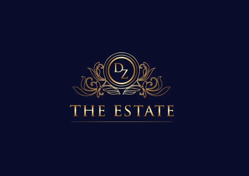 Logo for The Estate featuring gold decorative elements and the initials 'DZ' on a dark blue background.